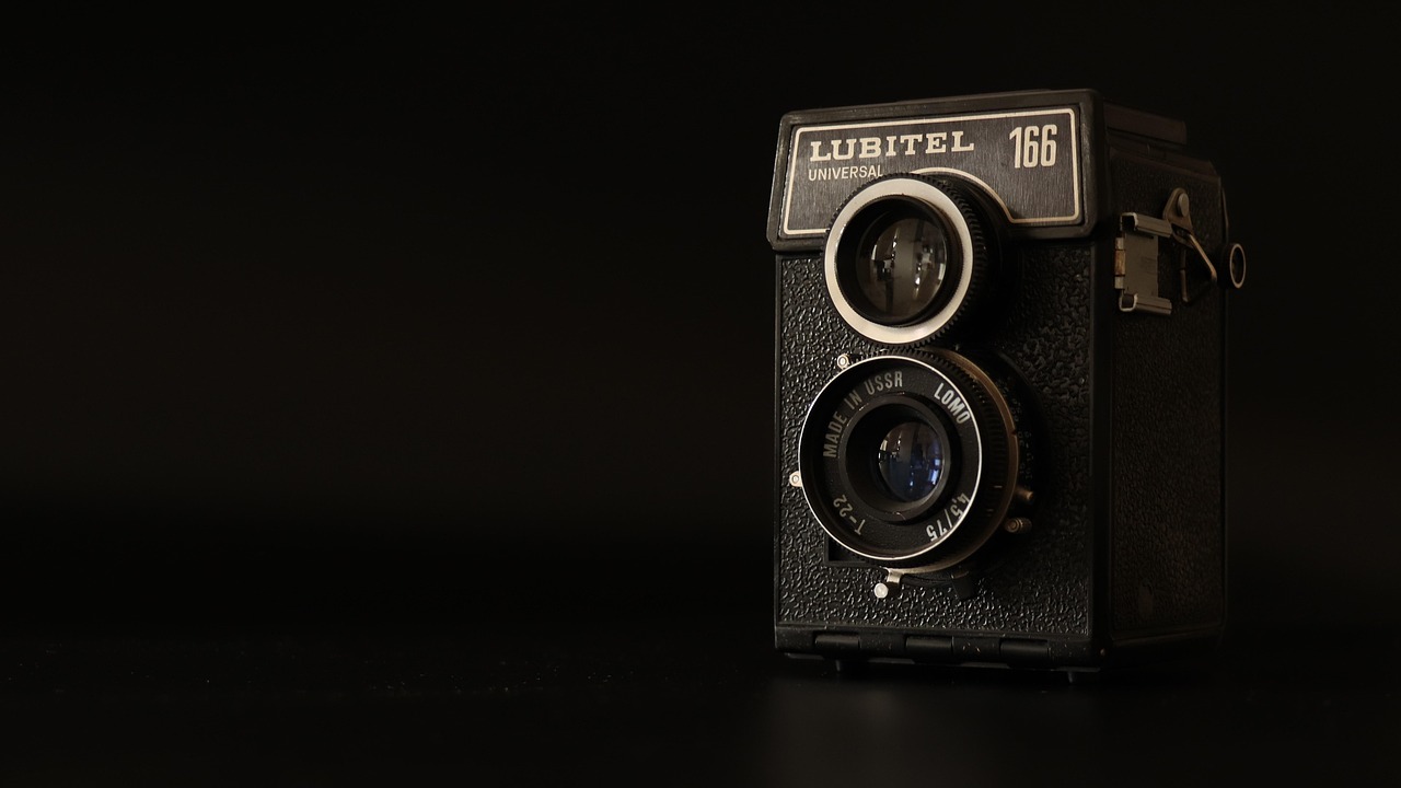 Vintage camera with two lenses against a black background